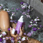 woman in bath with shaving cream and razor