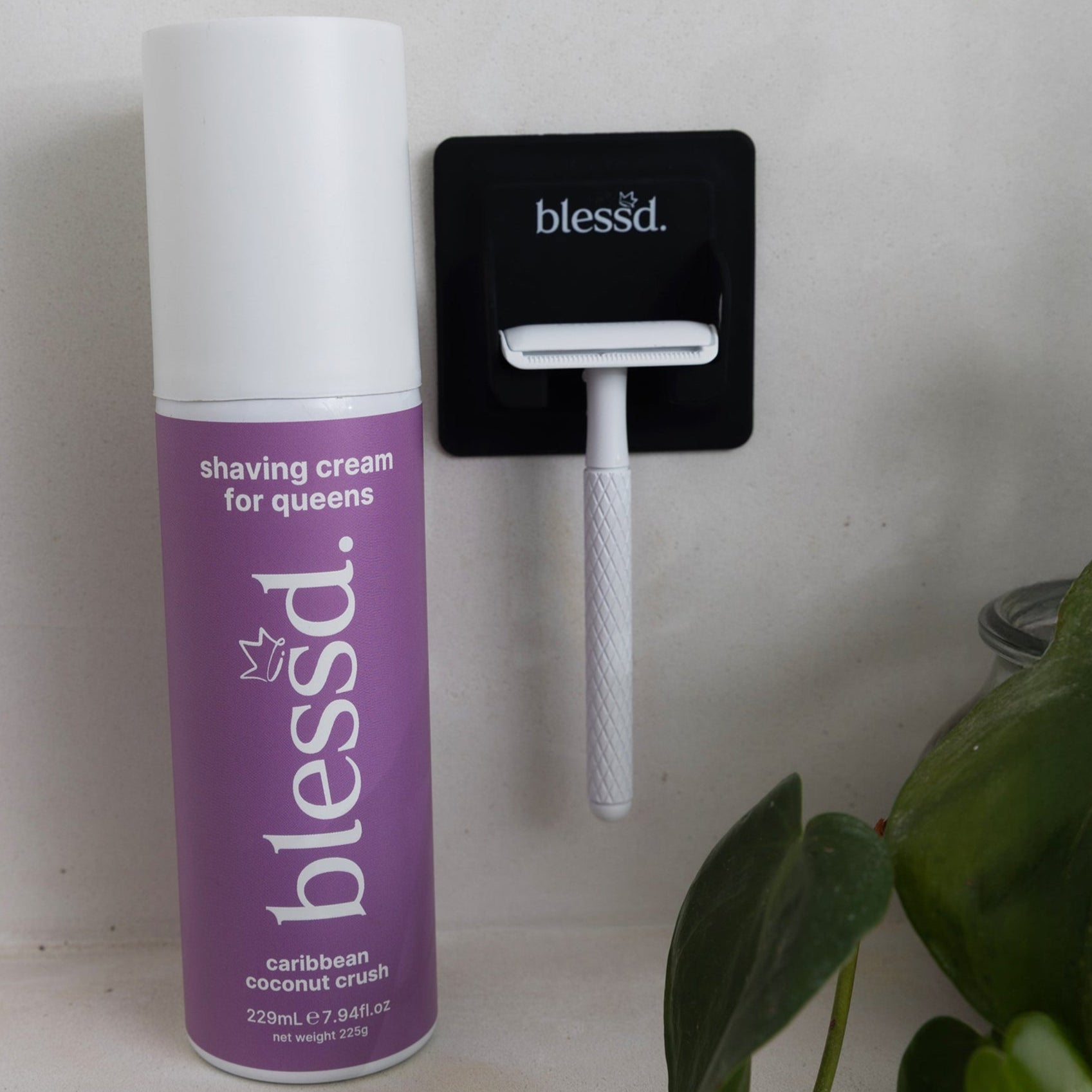 blessd womens shaving cream next to womans razor 