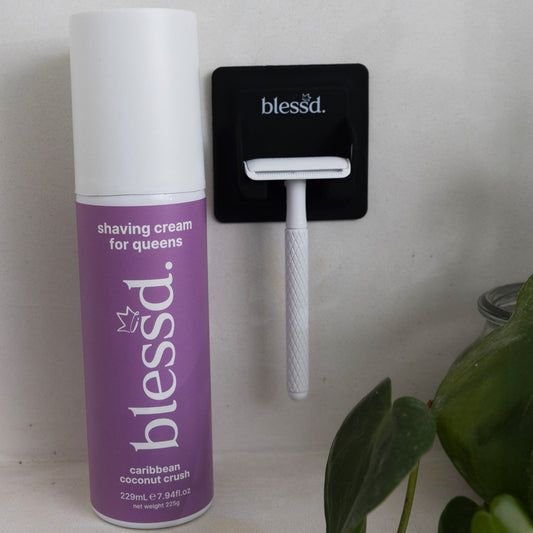 blessd womens shaving cream next to womans razor 